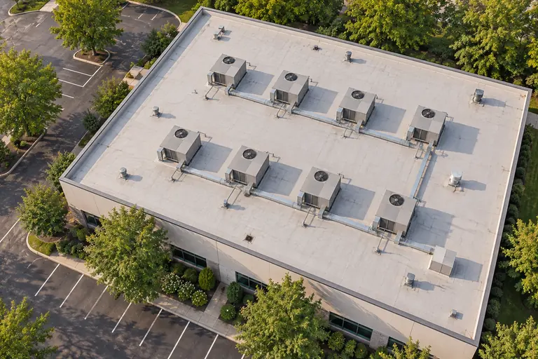 Illustrative flat commercial roof with rows of rooftop HVAC units