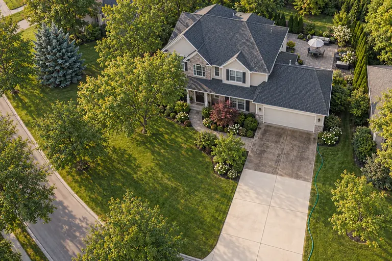 Illustrative home with a driveway half pressure-washed